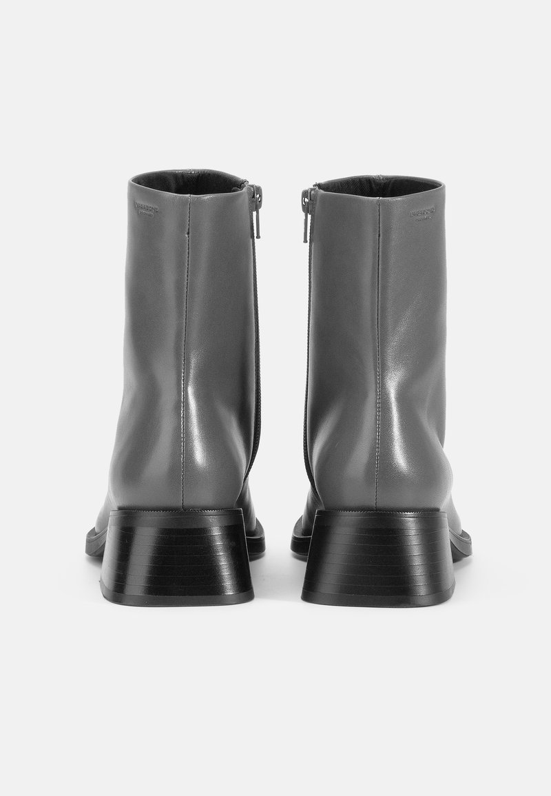 Gray leather ankle boots with a sleek design, featuring a side zipper and a ribbed black heel for added texture. Smooth surface finish.