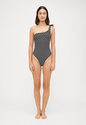 One-piece swimsuit in black and white geometric pattern, featuring an asymmetrical design with a tie accent on one shoulder. Smooth fabric.