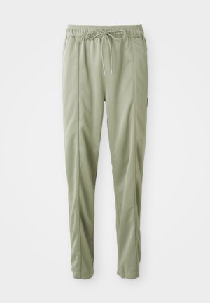 Lysgrønne taperede sweatpants med elastisk talje og snor, der har sidesømme og en afslappet pasform.