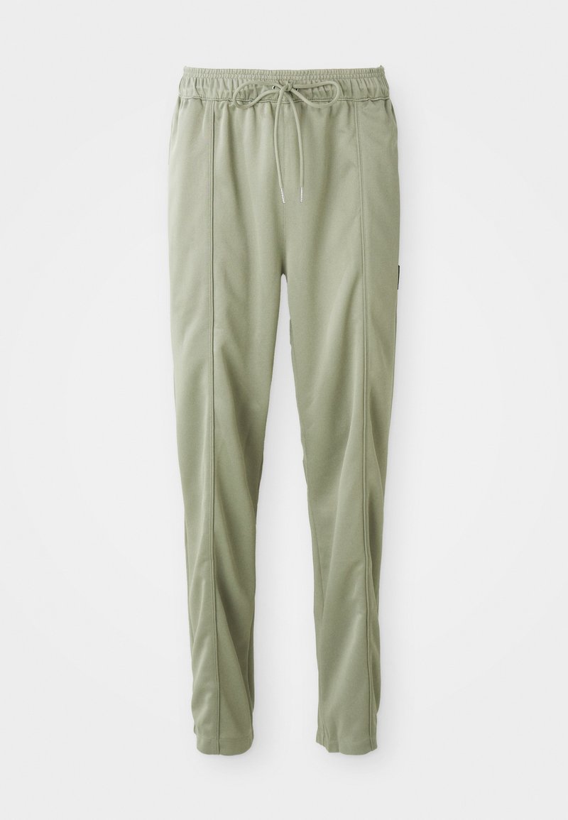 Lysgrønne taperede sweatpants med elastisk talje og snor, der har sidesømme og en afslappet pasform.