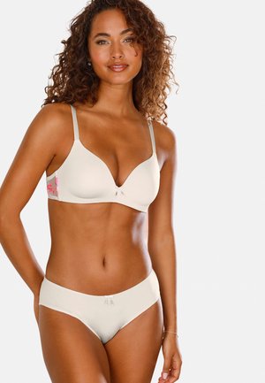 Beiger BH mit hellgrauen Trägern, mit floralem Design an der Seite. Der passende Slip hat eine glatte Textur und subtile dekorative Akzente.