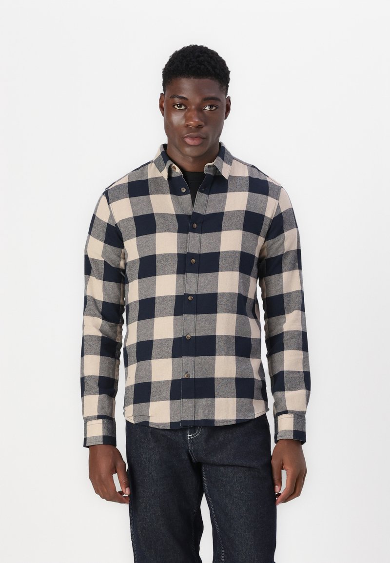 Camisa de cuadros para hombre en tonos azul marino y beige, con cuello botones, botones en el frontal y mangas largas con detalle en los puños.