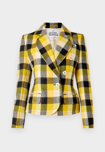 Blazer amarelo xadrez com grandes padrões de check preto e cinza, colarinho arredondado, quatro botões frontais e dois bolsos com aba.