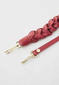 Dark red braided leather strap with gold hardware; features a smooth texture and a single gold stud accent. Ends with two metal clips.