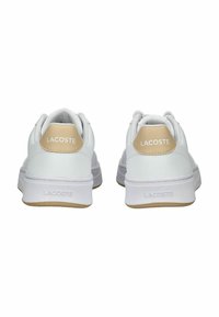 Weiße Ledersneaker mit einem beigefarbenen Absatz, strukturiertem Sohlenprofil und geprägtem Logo. Rundspitze und gepolsterter Kragen für zusätzlichen Komfort.