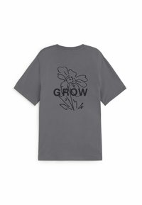 T-shirt gris à manches courtes avec un dessin au trait noir d'une fleur et le mot "GROW" centré dans le dos.