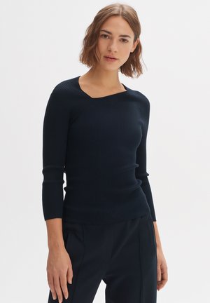 Marineblaues, geripptes Langarmoberteil mit einem Bootsausschnitt und figurbetonter Silhouette. Verfügt über einen strukturierten Stoff und ärmellange Ärmel.