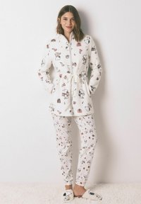 Biały polarowy szlafrok z postacią Snoopy i wzorami świątecznymi, z wiązaniem w pasie, w komplecie z pasującymi spodniami piżamowymi i puszystymi kapciami.