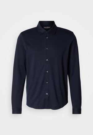 Mørkeblå langærmet skjorte lavet af blødt stof, med knapned krave, frontplacket med seks knapper og manchetter.