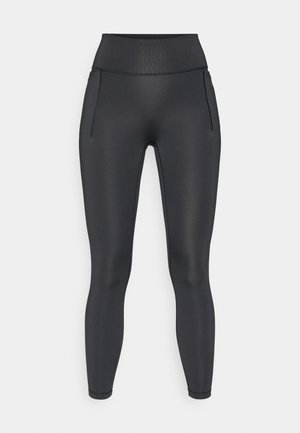 Collants noirs taille haute en tissu lisse et extensible. Dotés de deux poches latérales, d'un design élégant et d'une taille texturée.
