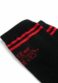 Black cotton socks with red stripes and text. Text reads "GAME OF THRONES." Soft texture, crew length design.