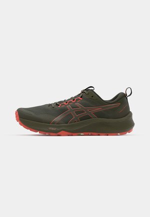 Green trail running shoes with a textured upper, orange accents, rugged outsole, and cushioned sole, designed for outdoor performance.