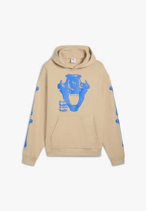 Beżowa bluza z kapturem z dużą niebieską grafiką czaszki na przodzie i niebieskimi akcentami na rękawach. Posiada kieszeń kangurkę oraz kaptur ze sznurkiem.