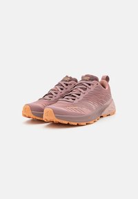 Lightweight trail shoes in pink and grey, featuring textured overlays, orange accents, and a rugged outsole for traction.