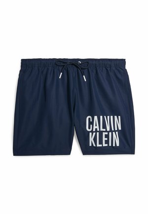 Bañadores de color azul marino con cintura elástica y cordón negro. Presenta un gran logo blanco de "CALVIN KLEIN" en el lado izquierdo.
