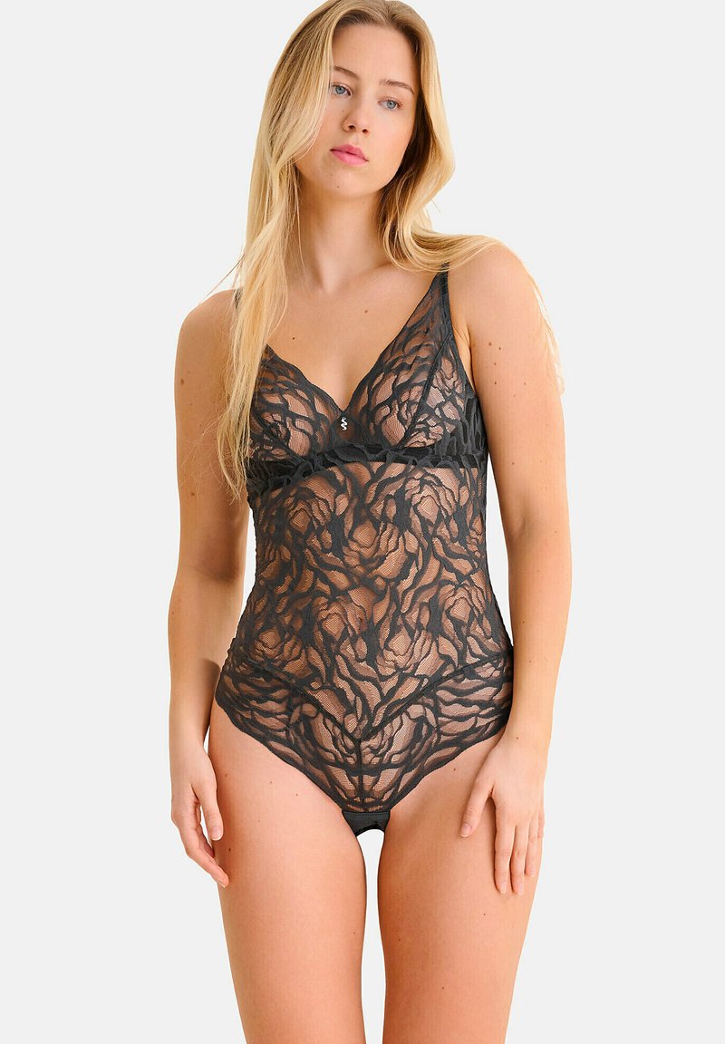 Bodysuit en dentelle noire avec motif floral, matériau transparent, design en V, bretelles ajustables et zone de poitrine doublée.