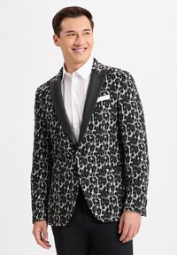 Schwarz-weißer Leopardenprint-Blazer mit satinierter Klappe, Ein-Knopf-Verschluss und einer Brusttasche. Glatte Textur und taillierte Passform.