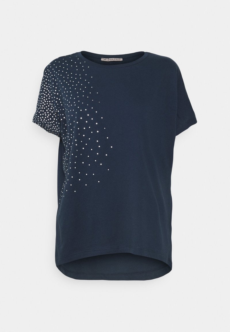 Navy blue short-sleeve shirt with silver dot pattern radiating from left shoulder to mid-torso, round neckline, and slightly curved hem.