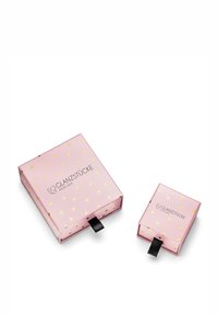 Dos cajas de regalo cuadradas, una más grande y otra más pequeña, en color rosa con patrones de hojas de oro. Ambas tienen cintas de tiro negras y presentan el logo "GLANZSTÜCKE MÜNCHEN."