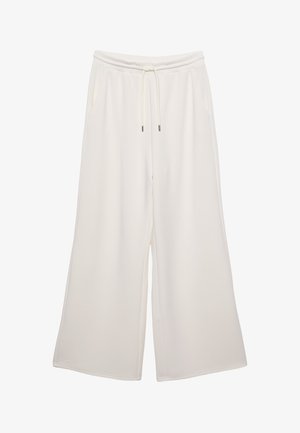 Pantaloni a gamba larga di colore crema, realizzati in tessuto morbido, con vita elastica, cordoncino e tasche laterali. Texture liscia.