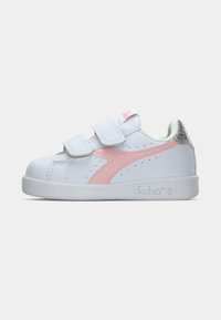 White sneaker with pink accents, velcro straps, and a textured heel. Smooth material and perforated detailing on the sides.