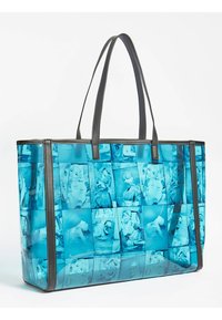 Grote draagtas van transparant blauw materiaal met een collage van beelden in verschillende tinten, met zwarte synthetische leren handvatten en randen.