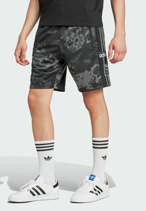 Black and gray camo sports shorts with a slick texture, featuring three black stripes on the sides and an Adidas logo patch on the front.