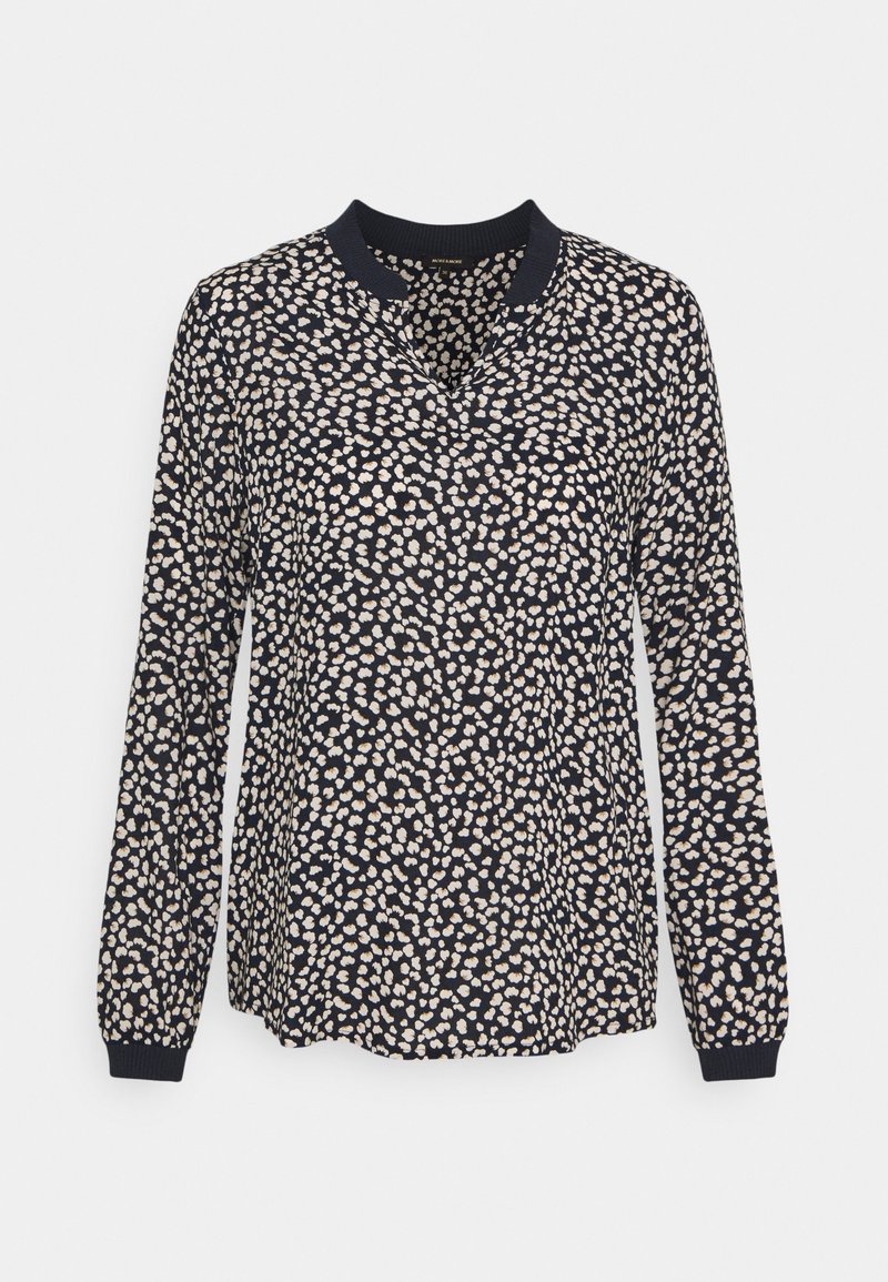 Blouse marine à manches longues, décolleté en V, avec un motif texturé de pois blancs et beiges, dotée de poignets et d'un col côtelés.