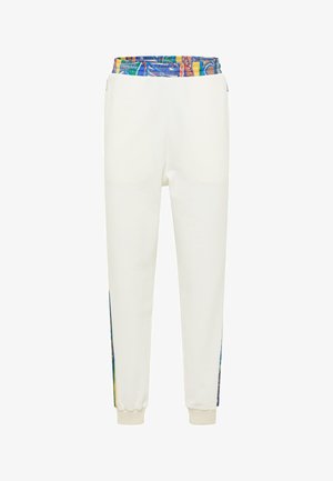 Hvide sweatpants har en farverig elastisk talje og mønstrede sidelåse. Buksebenene har elastiske manchetter for en tæt pasform.