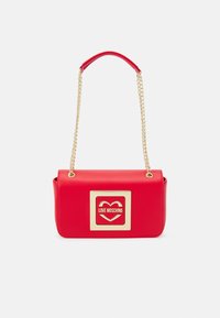 Borsa a tracolla in finta pelle rossa con catena dorata, logo quadrato con cuore, forma rettangolare e texture liscia.