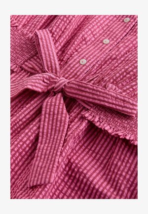 Rozā svītrains auduma tērps ar mezglotu saiti, pogu aizdari, teksturētu smoku augšdaļu un volānu apakšmalu.