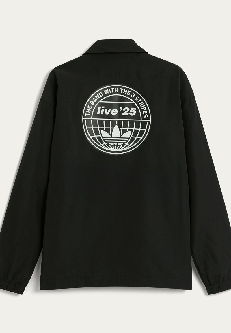 Black long-sleeve jacket featuring a circular graphic on the back with text and a globe design. Lightweight fabric with a relaxed fit.