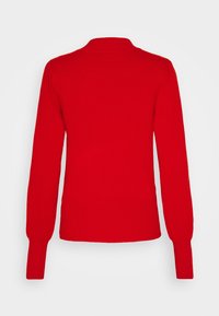 Red sweater with long sleeves, ribbed hem and cuffs, and a collar. Made of soft fabric with a smooth texture and no visible patterns.