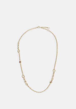 Collier chaîne en or avec trois maillons torsadés en forme d'infini et deux petites perles rondes rayées, posé à plat sur un fond blanc.