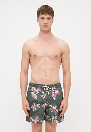 Blumige Badeshorts mit dunkelgrünem Grundton, verziert mit rosa und weißen botanischen Mustern, elastischem Bund und Kordelzugverschluss.