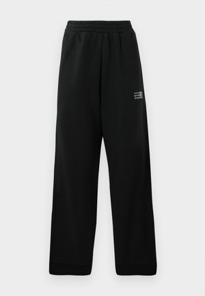 Black sweatpants made of soft fabric, featuring a loose fit, elastic waistband, and a small white printed logo on the side.