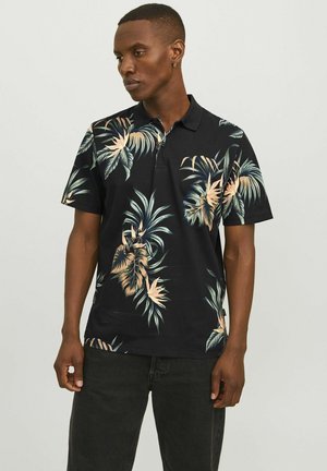 Sort polo skjorte med et tropisk planteprint i grønne og beige nuancer. Korte ærmer, krave og afslappet pasform. Blødt bomuldsblanding stof.