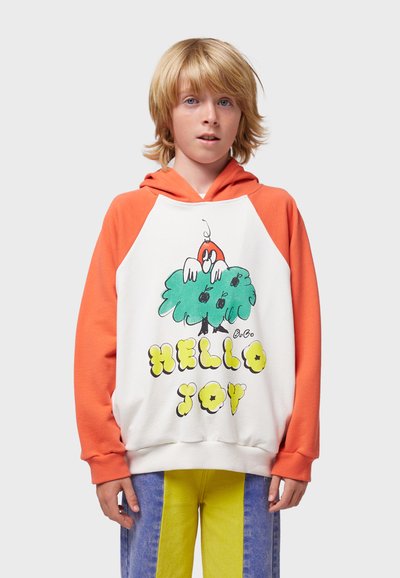 Sudadera con mangas naranjas y cuerpo blanco que presenta un diseño de caricatura de un árbol, con el texto impreso "HELLO JOY" en amarillo. Textura de tela suave.