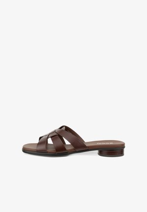 Brown leather slip-on sandal with crisscross straps and a low stacked heel, featuring a flat sole and open toe design.