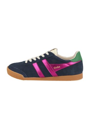 Navy suede sneakers with pink metallic stripes, beige laces, and green accents. Features a textured gum rubber sole for grip. Gola logo present.