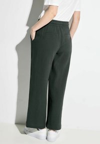 Donkergroene, gestructureerde broek met wijde pijpen heeft een relaxte pasvorm, elastische tailleband, zijzakken en een subtiel ruitpatroon.