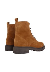 Las botas de tobillo de ante marrón presentan una puntera redonda, detalles de cordones y una suela de goma negra resistente con una textura para mayor agarre.