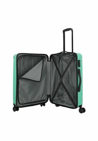 Hartschalenkoffer in Minzgrün mit einem integrierten, ausziehbaren Griff. Das Innere ist mit grauem Stoff ausgekleidet und verfügt über verstellbare Packgurte.