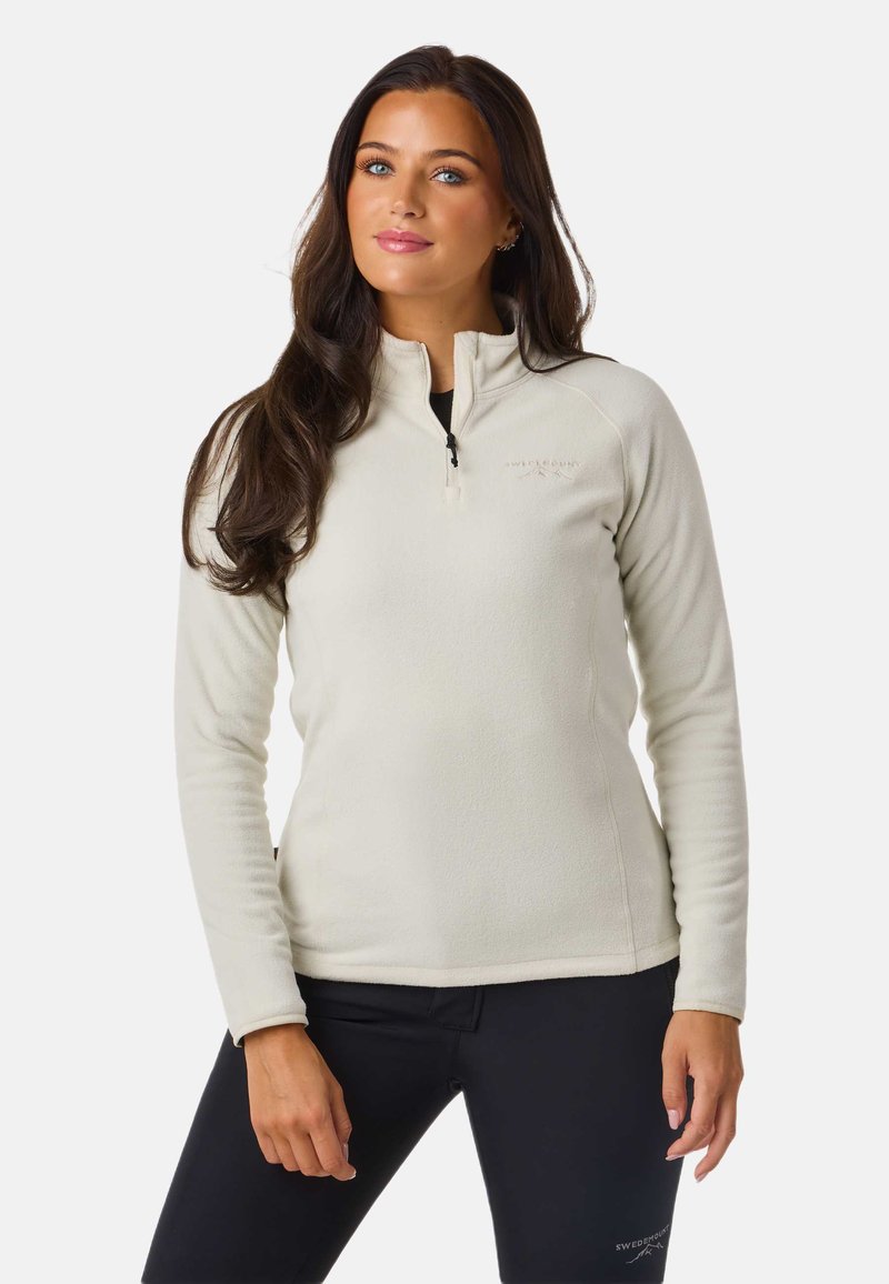 Lyscreme fleece-pullover med lynlås i halsen, lange ærmer og en glat tekstur. Har diskret branding på brystet.