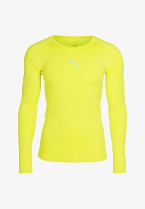 Maglietta sportiva a maniche lunghe di un vivace giallo. Realizzata in materiale liscio e elasticizzato, con scollatura rotonda e un piccolo logo bianco sul petto.