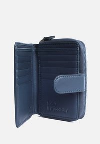 Navy leather wallet with a zip closure, multiple card slots, and a snap button. Text embossed: "today is a good day." Smooth texture.
