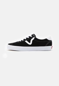 Black suede sneakers with white accents, rounded toe, white rubber sole, and black laces. Notable side logo detail in white stitching.