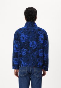 Lacoste Mezisezónní bunda  - globe/navy blue/lazuli