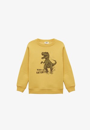 Sudadera amarilla con cuello redondo, mangas largas y puños de canalé. Presenta un gráfico de dinosaurio y el texto "LISTO PARA ATRAPARLO."