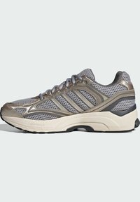 Mesh running shoe in gray with metallic accents, featuring a padded collar, hexagonal perforations, and a textured white sole.